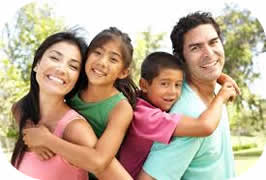 Parents and children smiling together outdoors